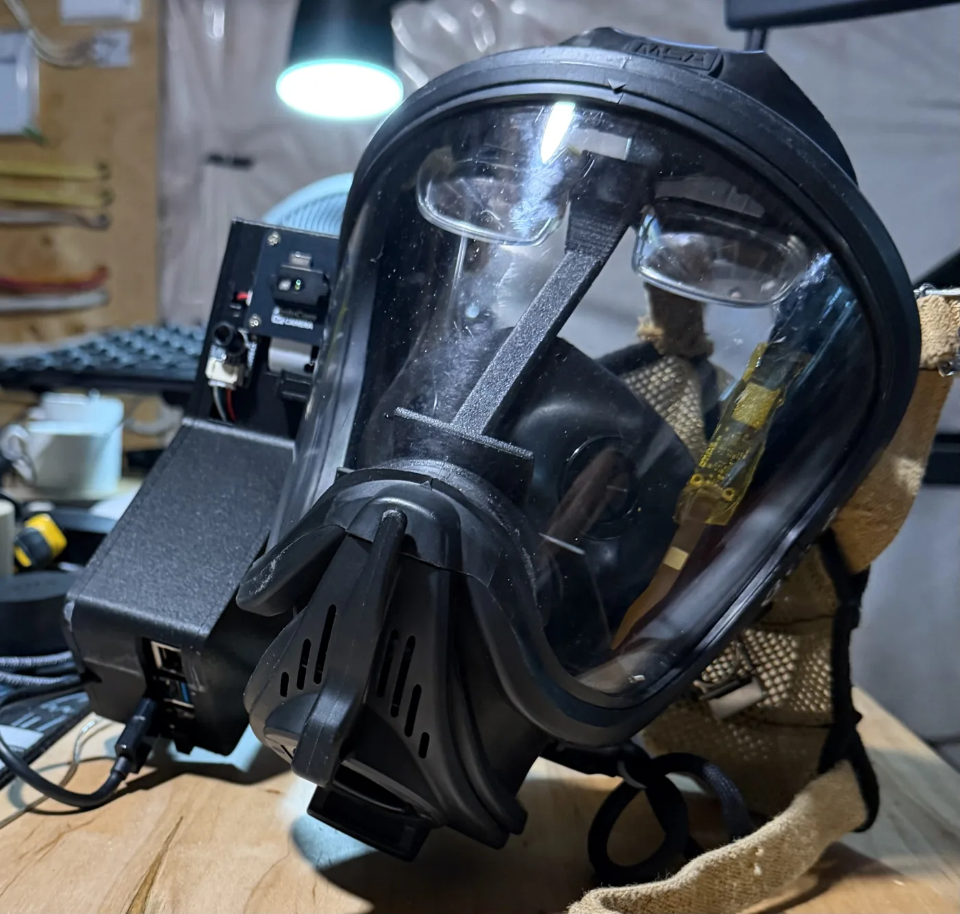 The Ember prototype: an MSA SCBA firefighting mask fitted with a camera module, compute pack, and heads-up display.