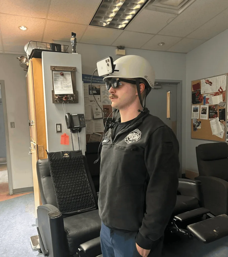 A firefighter trying on the helmet-mounted Ember rig at a fire station.