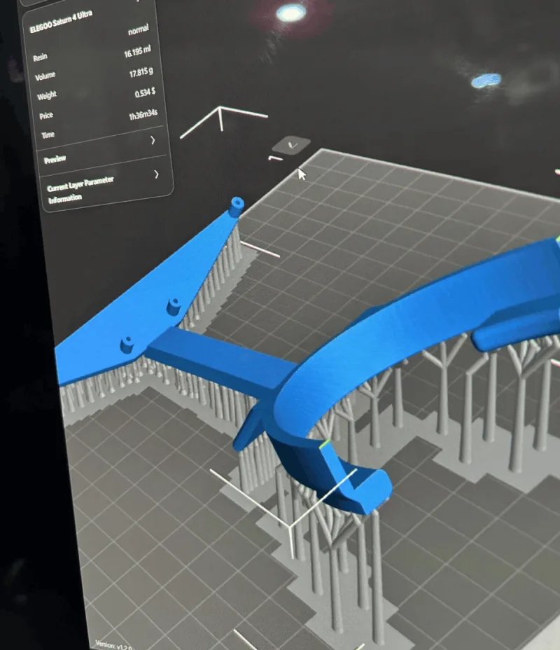 A resin printer slicer previewing the Ember mask mounting bracket with supports.